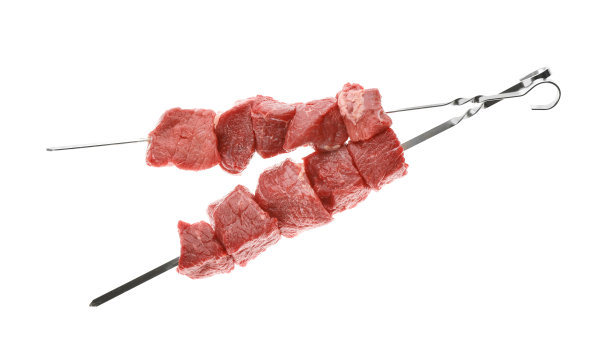 白色背景上有生肉的金属串图片下载