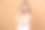 美丽的白人女人的美丽肖像在白色毛巾看相机和拿遮瑕瓶近脸，孤立的米色背景图片下载