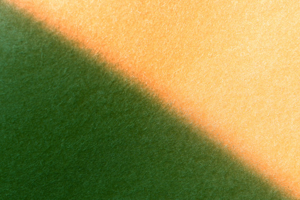 毛毡织物纹理背景黄色和绿色两种色调的背景与复制空间。图片下载