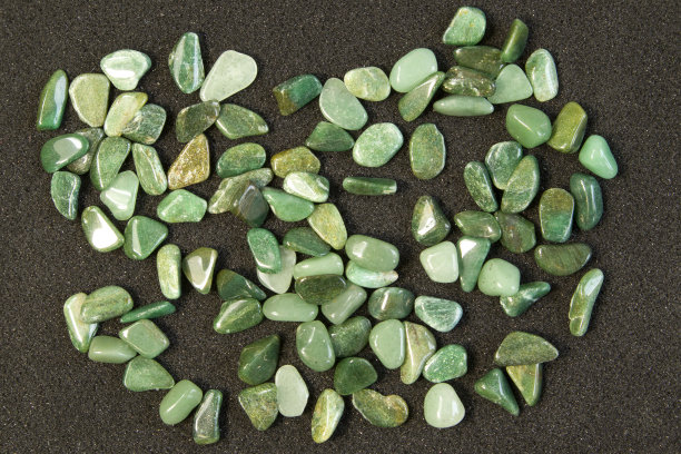 矿物岩石标本的宏观照片-黑色背景上的绿色砂砾岩宝石图片下载