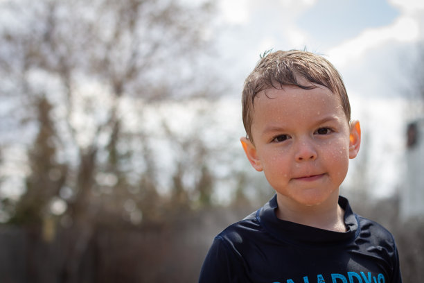 夏天小男孩在洒水器里的肖像图片下载
