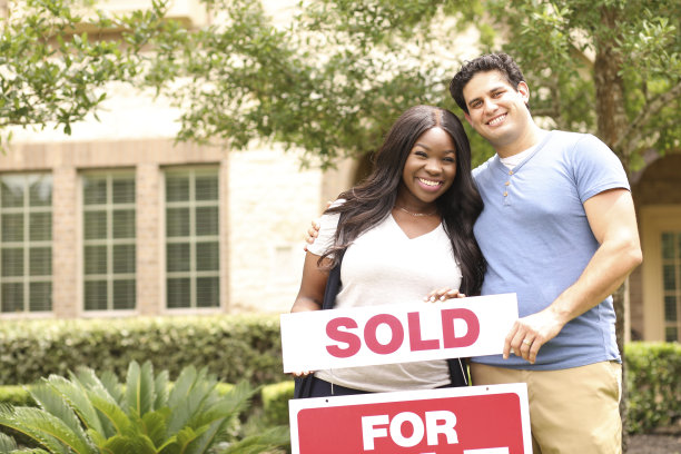 兴奋的年轻夫妇购买了他们的第一套房子。图片下载