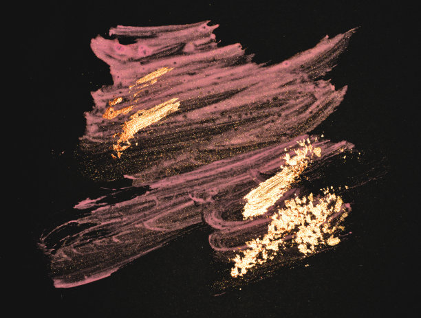 抽象的金色和粉色手绘污渍在黑色的背景图片下载