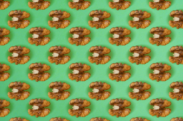 核桃图案的绿色背景。平的。图片下载