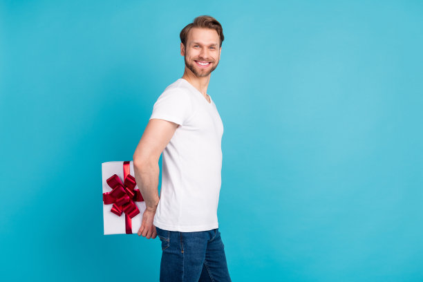 正面人物的资料照片手拿礼盒背后看相机孤立在蓝色背景图片下载