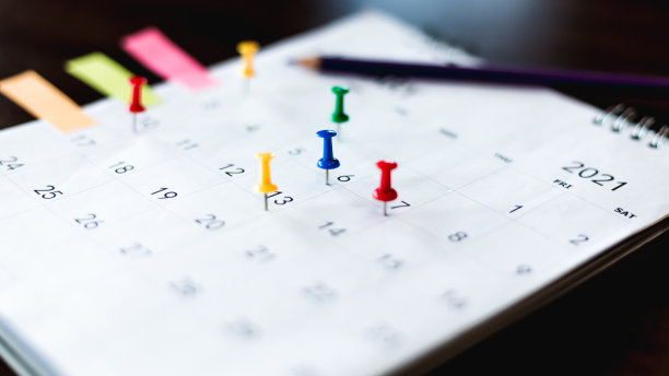 近距离的日历放在木桌上，策划商务会议或旅游策划的概念。图片下载