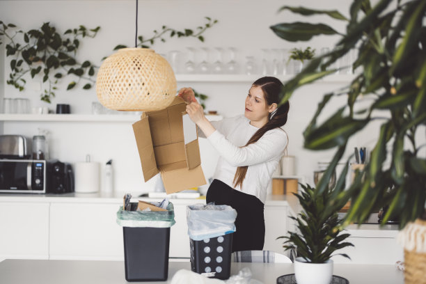 年轻妇女在家里回收废纸图片下载