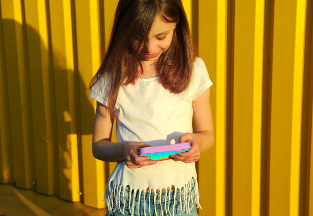 小女孩把手指按在一个抗压玩具上。图片下载