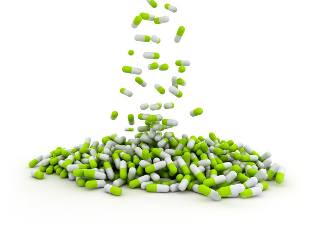 落在白色背景上的绿色药丸胶囊图片下载