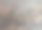 一个平坦的自然深色石头表面与棕色斑点和小坑近距离。图片下载