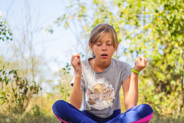 散焦高加索女孩练习瑜伽在公园，森林，户外，外面。张口冥想和集中注意力。健康健康的生活方式。瑜伽的女孩。绿色背景。的焦点图片下载