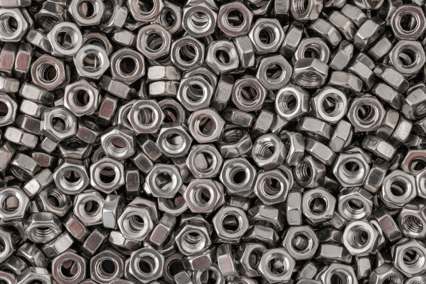 不锈钢螺母背景微距照片。图片下载