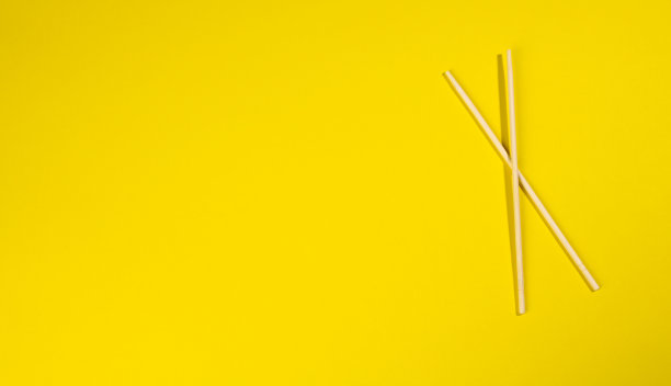 黄色背景上的两根木筷子图片下载