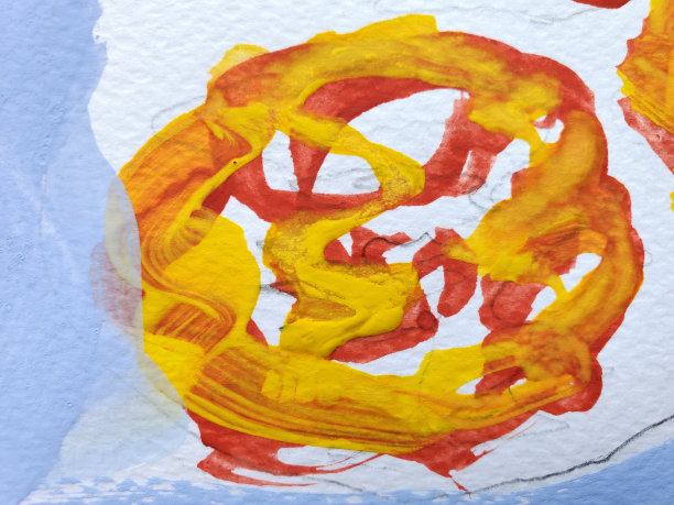 黄色和红色颜料在水彩纸上混合图片下载