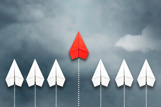 红纸飞机在一群白种人面前飞行。多云的天空。领导理念、团队合作、人事管理。业务。的生活方式。图片下载
