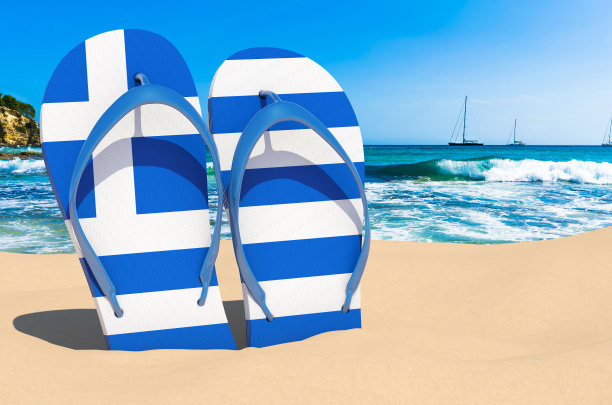 沙滩上穿着印有希腊国旗的人字拖。希腊度假村，度假，旅游，旅游套餐概念。三维渲染图片下载