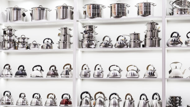 新的烹饪用具，各种不锈钢锅，金属茶壶的展示柜在商店的货架上出售图片下载