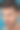 近景肖像英俊的黑发男子与湿洗脸一边看，在蓝色背景孤立图片下载