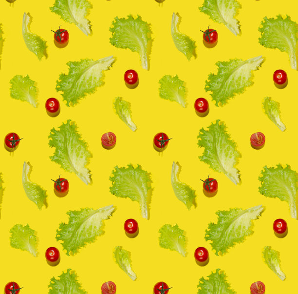食物色彩丰富的蔬菜无缝图案-圣女果，绿色沙拉的叶子在坚硬的光与阴影在黄色的背景，平铺，方形。图片下载