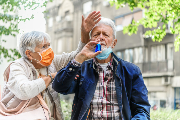 照片一个生病的老人在户外鼻窦炎问题和他的小心的妻子。图片下载