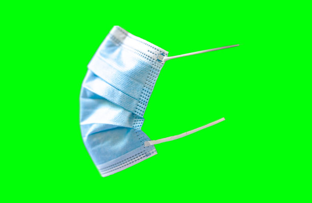 医用口罩，侧视图，绿色背景，covid-19呼吸道疾病，大流行图片下载