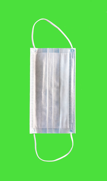 医用口罩内部，新冠肺炎大流行，绿色背景，白色呼吸过滤器图片下载