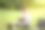 户外学习。微笑的亚洲男学生在公园的草坪上看书图片下载