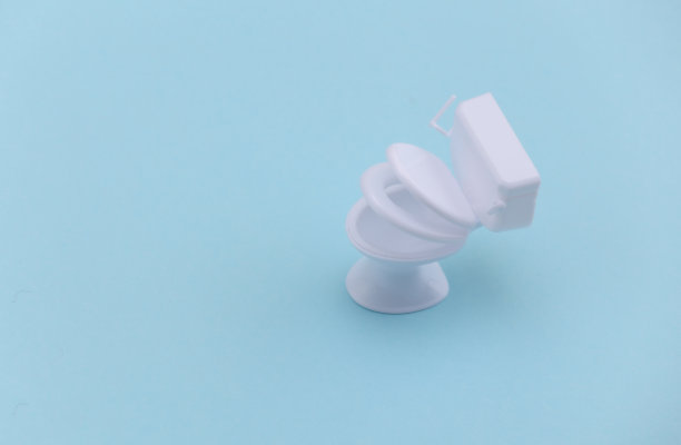 蓝色背景上的迷你白色马桶。极简主义。图片下载