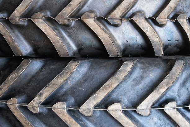 背景是两个巨大的拖拉机轮胎互相压在一起图片下载