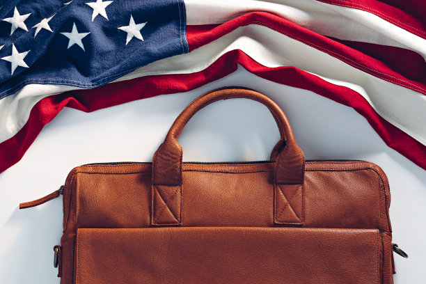白色背景上的公文包和美国国旗。商业和工作在美国的概念。图片下载