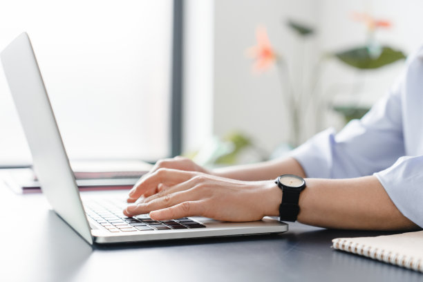 近距离拍摄了一个女人在家里办公时用笔记本电脑打字的照片。自由职业者，远程职业，导师，电子学习概念图片下载