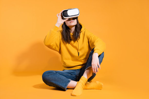 沉浸于网络空间、虚拟现实和用户。一个穿着黄色连帽衫的玩家图片下载