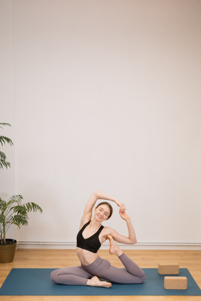 美丽的年轻女子在室内练习瑜伽的肖像图片下载