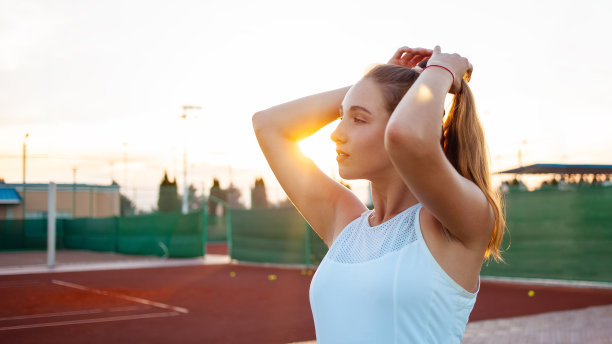 一个美丽的女人在日落的肖像。网球场，健壮的身体。健身，减肥，运动员微笑，快乐。在户外积极的生活方式。阳光明媚，享受户外图片下载