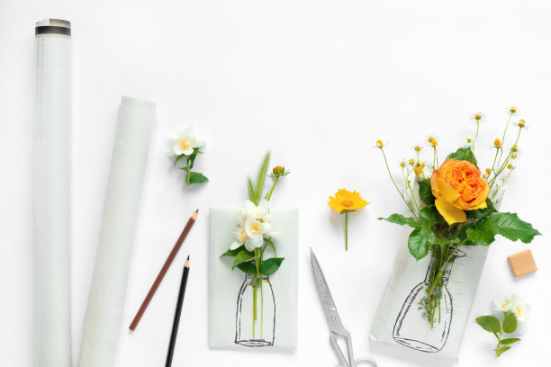 手工包装纸和鲜花套装，白色背景。自制工艺礼品盒，配有彩绘花瓶、黄色玫瑰花束和精致的雏菊图片下载