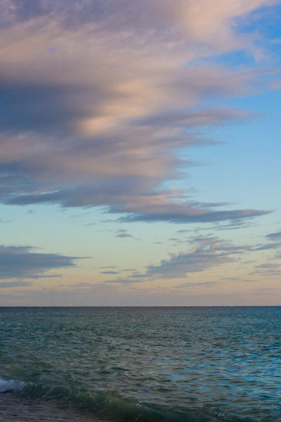 卵石滩上惊人的海上日落，太阳，海浪，云彩图片下载
