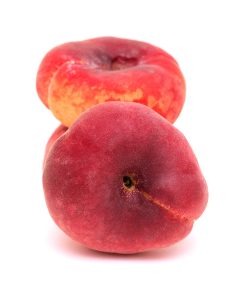 大的黄色和红色扁平桃子果实孤立在白色的背景上图片下载