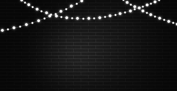 明亮的白光花环在黑色的砖墙背景上图片下载