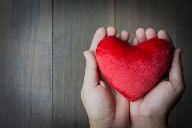 成人手捧红心、心脏健康、捐赠、快乐志愿慈善、CSR社会责任、世界心脏日、世界卫生日、世界精神卫生日、家庭日、寄养家庭、器官捐赠日库存照片。图片下载