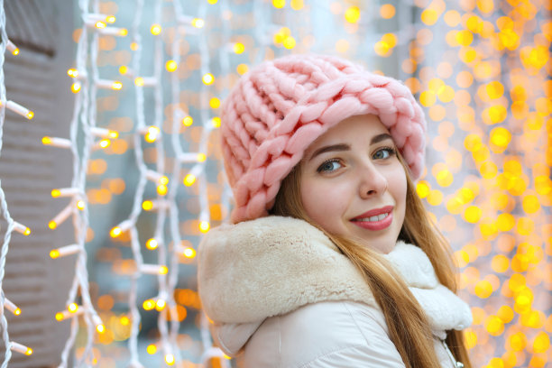迷人的女孩在灯光旁摆姿势图片下载