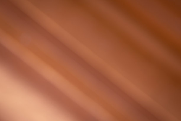 金属铜背景图像。(倾斜的渐变)光线反射在箔上。图片下载
