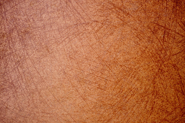 模糊的、旧的、有划痕的、橙色的灰泥墙。近距离图片下载