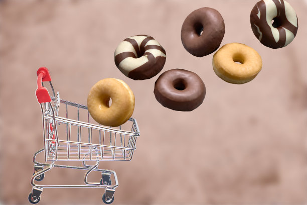 组成不同类型的甜甜圈落入购物车。脂肪食物的概念。甜的食物。图片下载