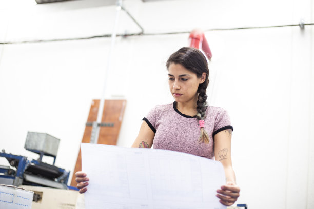 在印刷机工作的年轻女子图片下载