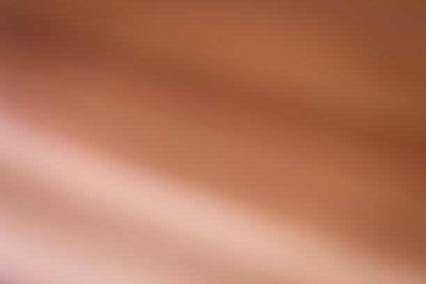 金属铜背景图像。(倾斜的渐变)光线反射在箔上。图片下载