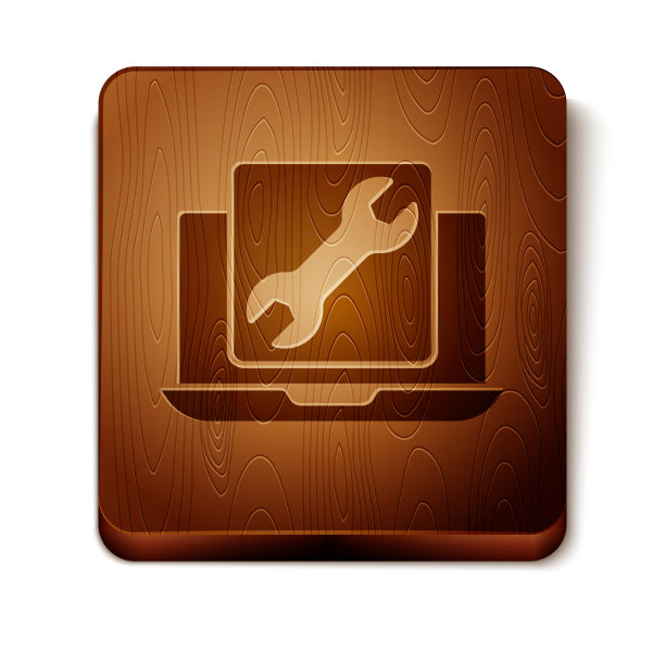 棕色笔记本电脑与扳手图标隔离在白色图片下载