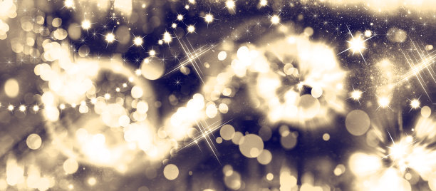 金色假日抽象闪光散焦背景与闪烁的星星和花环。发光的金色背景。图片下载
