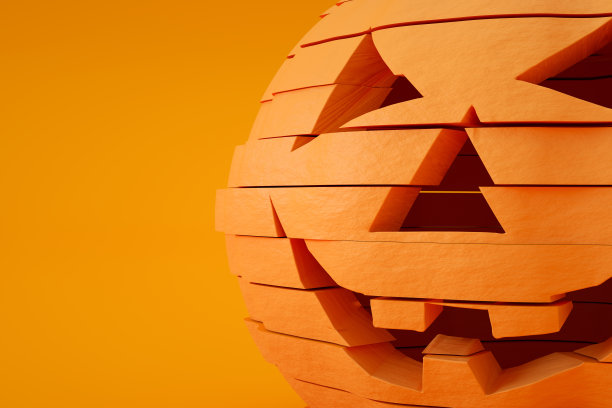 切片南瓜万圣节与幽灵的脸，杰克O'灯笼，橙色的背景图片下载