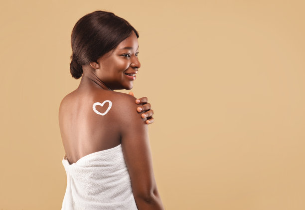 年轻美丽的黑人女性肩膀上的身体霜制成的心脏图片下载