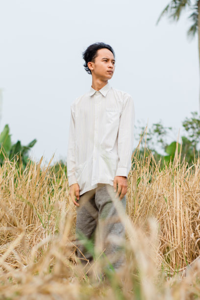 穿着白衬衫的年轻人站在球场上图片下载